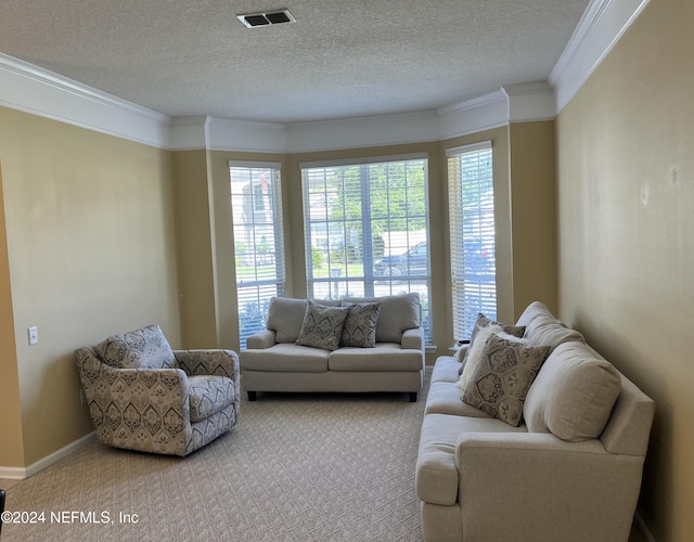 living area with carpet floors, a healthy amount of sunlight, visible vents, and crown molding
