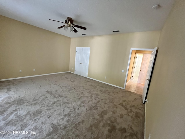 unfurnished bedroom with carpet floors, visible vents, ceiling fan, and baseboards