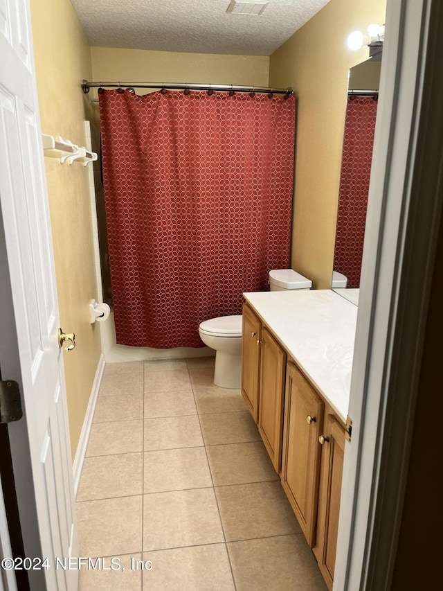 full bath with a shower with curtain, toilet, a textured ceiling, vanity, and tile patterned flooring
