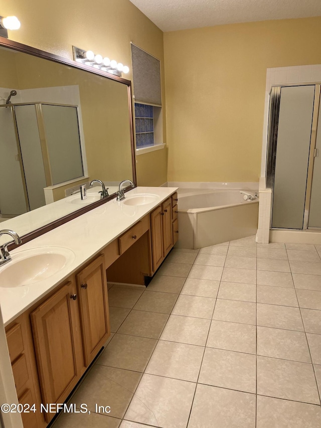 full bath with double vanity, a sink, and tile patterned floors