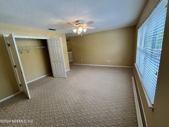 unfurnished bedroom featuring a closet, carpet flooring, visible vents, and baseboards