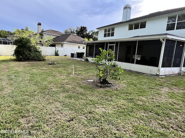 view of yard with fence and a sunroom