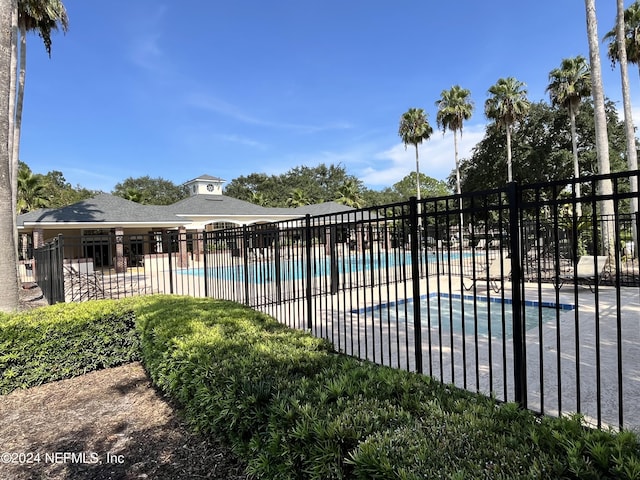 pool featuring a patio area and fence