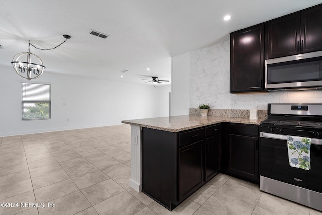 kitchen with stainless steel appliances, light stone counters, ceiling fan with notable chandelier, light tile patterned floors, and kitchen peninsula