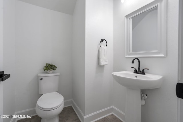 bathroom with tile patterned flooring and toilet