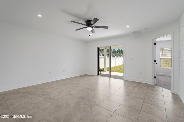 tiled empty room with ceiling fan