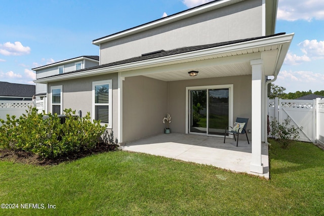 rear view of house with a patio area and a yard