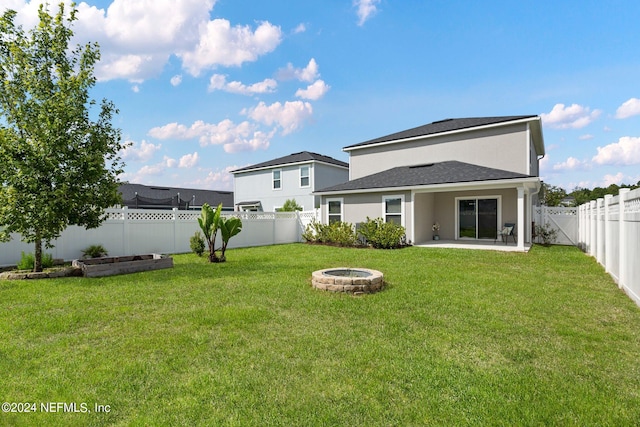 back of property featuring an outdoor fire pit, a patio area, and a yard