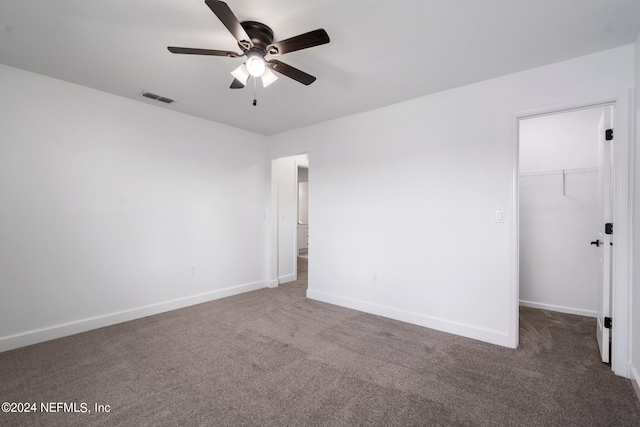 empty room with ceiling fan and carpet