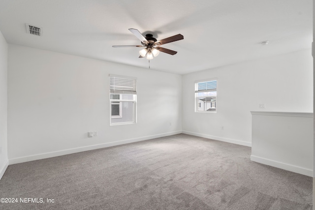 carpeted empty room featuring ceiling fan