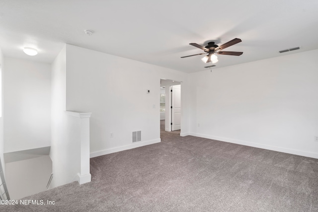 empty room featuring carpet floors and ceiling fan