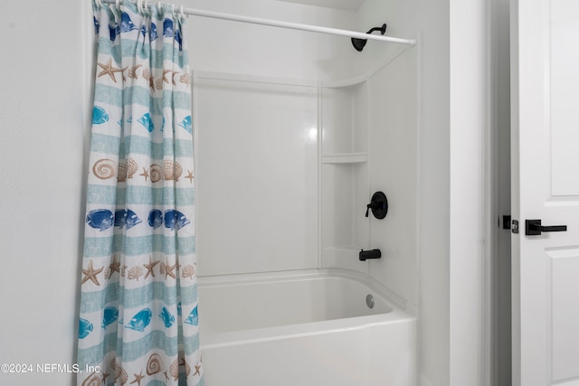 bathroom with shower / bath combo with shower curtain