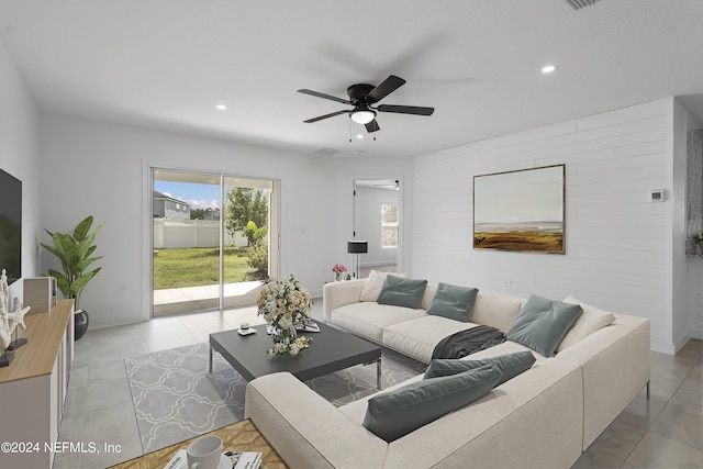 living room featuring ceiling fan and light tile patterned floors