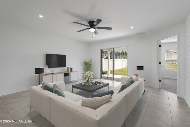 living room with ceiling fan and light carpet