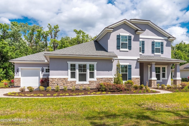 view of front of property with a garage, a front yard, and a porch