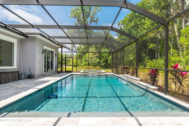 view of swimming pool featuring an in ground hot tub, a lanai, and a patio area