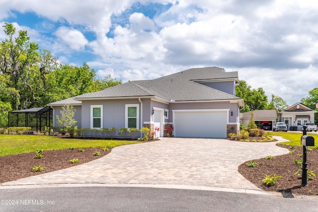 view of front of house featuring a garage and a front lawn