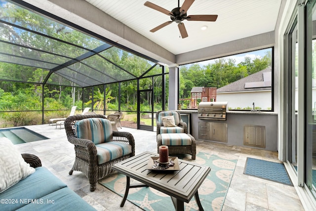 sunroom / solarium with ceiling fan and sink