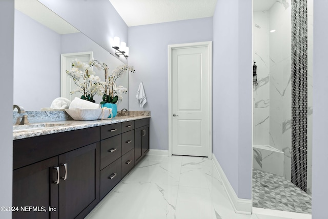 bathroom with vanity and tiled shower