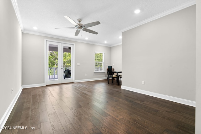 empty room featuring crown molding, dark hardwood / wood-style floors, a textured ceiling, and french doors