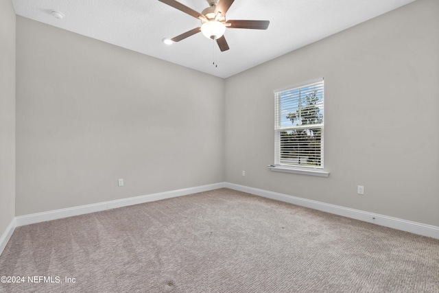 spare room featuring carpet and ceiling fan