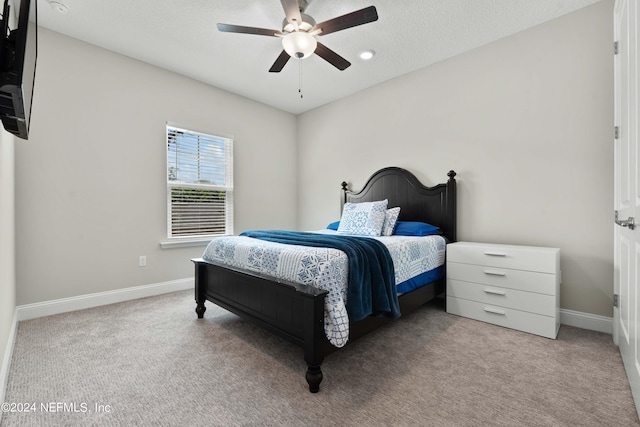 bedroom with light carpet and ceiling fan