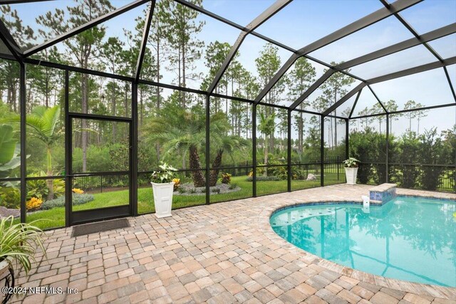 view of pool with a patio and a lanai