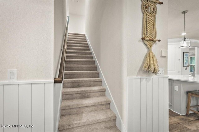 stairs with hardwood / wood-style floors