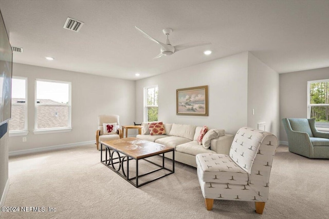 carpeted living room with plenty of natural light and ceiling fan