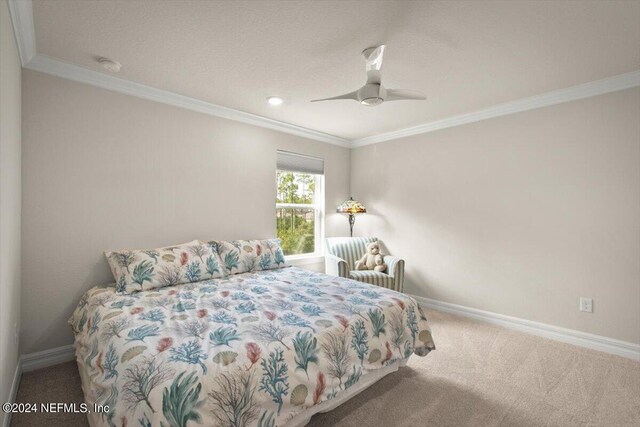 bedroom featuring ornamental molding, carpet, and ceiling fan