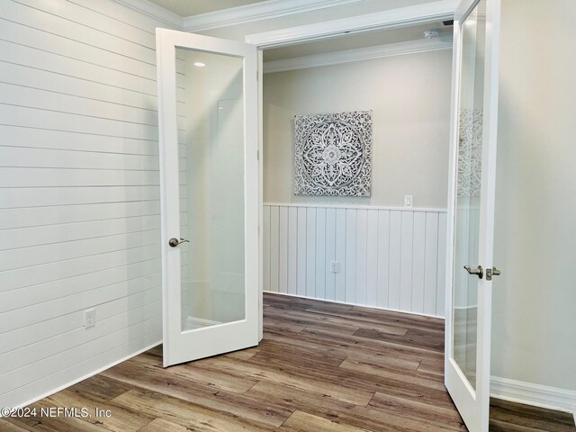 interior space featuring french doors, wood-type flooring, and ornamental molding