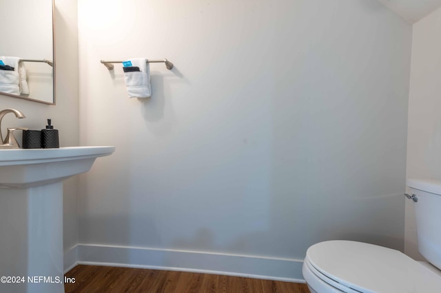 6833 A Ave, Saint Augustine, FL 32080 - bathroom with toilet, baseboards, and wood finished floors