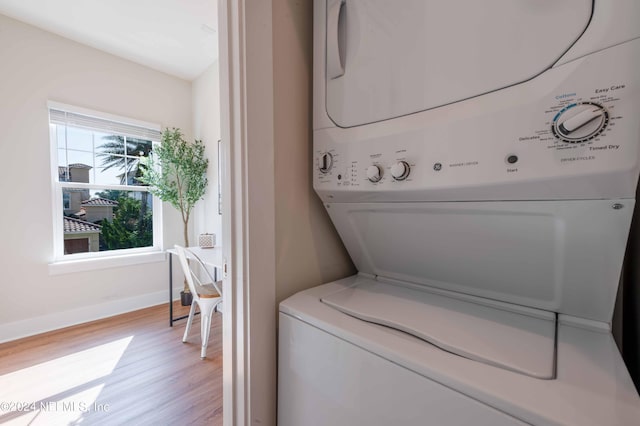 6833 A Ave, Saint Augustine, FL 32080 - washroom featuring stacked washing machine and dryer, light wood-type flooring, and baseboards