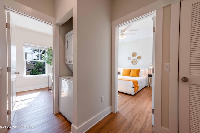 6833 A Ave, Saint Augustine, FL 32080 - laundry room featuring stacked washing machine and dryer, light wood-style flooring, baseboards, and ceiling fan