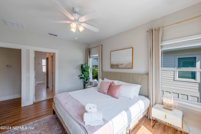 6833 A Ave, Saint Augustine, FL 32080 - bedroom with multiple windows, wood finished floors, a ceiling fan, and baseboards