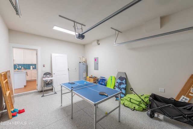 6833 A Ave, Saint Augustine, FL 32080 - rec room featuring a garage, water heater, electric panel, and dark speckled floor