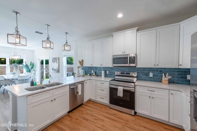 6833 A Ave, Saint Augustine, FL 32080 - kitchen featuring appliances with stainless steel finishes, a sink, a peninsula, decorative backsplash, and recessed lighting