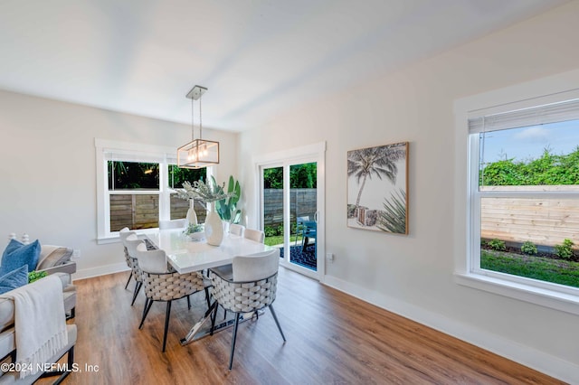6833 A Ave, Saint Augustine, FL 32080 - dining room featuring baseboards, wood finished floors, and a chandelier