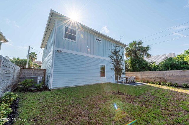 6833 A Ave, Saint Augustine, FL 32080 - back of property with board and batten siding and a patio area