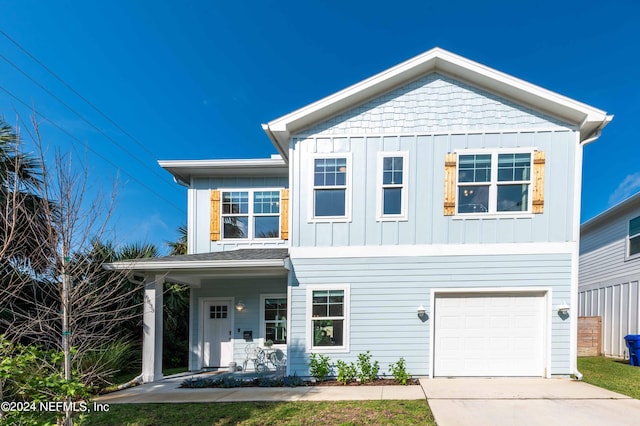 6833 A Ave, Saint Augustine, FL 32080 - view of front of home with an attached garage, board and batten siding, and driveway