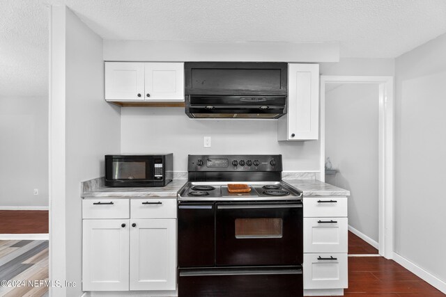 kitchen with hardwood / wood-style floors, white cabinetry, black appliances, a textured ceiling, and range hood