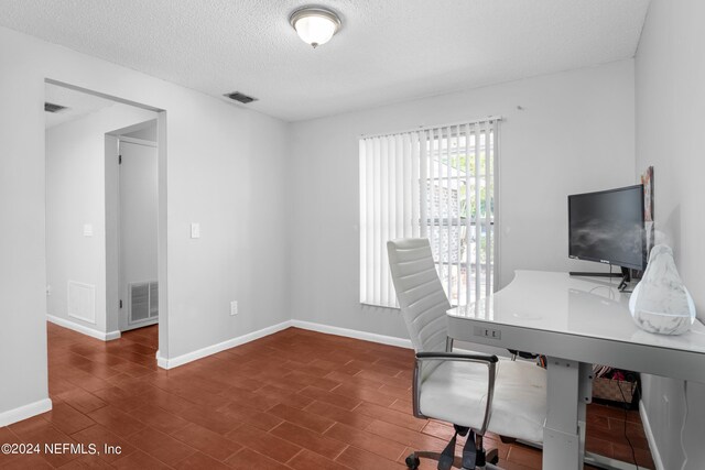 office area with a textured ceiling