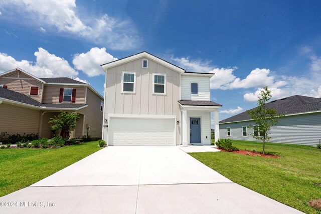 view of front of property with a front lawn and a garage