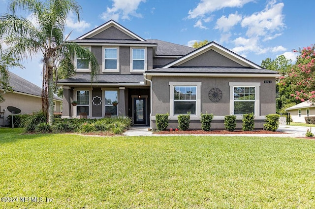 view of front of property with a front yard and stucco siding