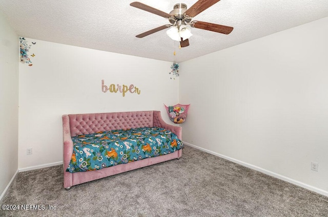 bedroom with ceiling fan, a textured ceiling, and carpet flooring