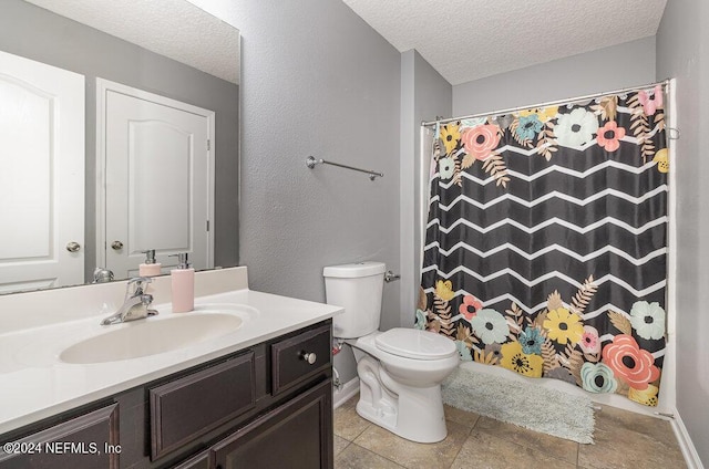 bathroom featuring baseboards, toilet, a shower with curtain, a textured ceiling, and vanity