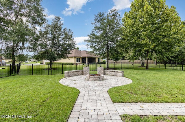 view of yard featuring a patio area, a fenced backyard, and a fire pit