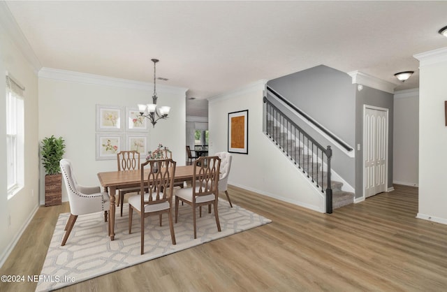 dining space with stairs, crown molding, a notable chandelier, and light wood-style floors