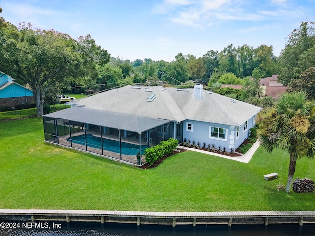 back of house with a lanai, an outdoor pool, a chimney, and a lawn