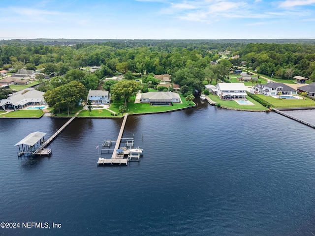 bird's eye view with a water view and a forest view